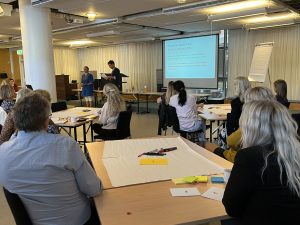 People sitting at different tables to participate in the CHERRIES workshop facilitated by Anestis Amanatidis, Researcher at Leiden University in the Netherlands.